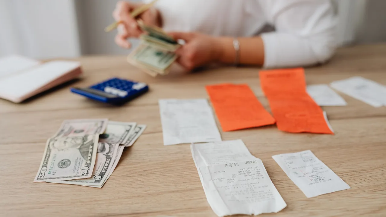 Paper receipts and coins on a desk for tracking expenses