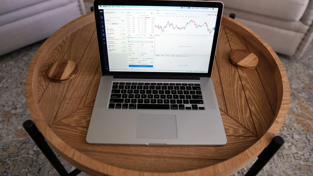 A personal finance dashboard with charts open on a laptop screen